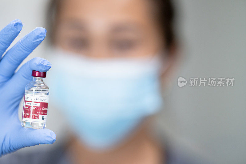Medical worker holding bottle of vaccine